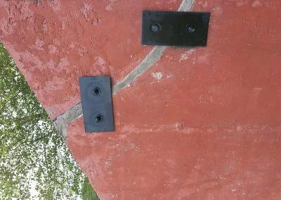 Foundation repair brackets installed on a residential wall, showcasing structural support solutions by Southern Structural Solutions.